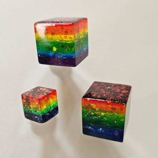 Three rainbow-colored cubes on a light gray background